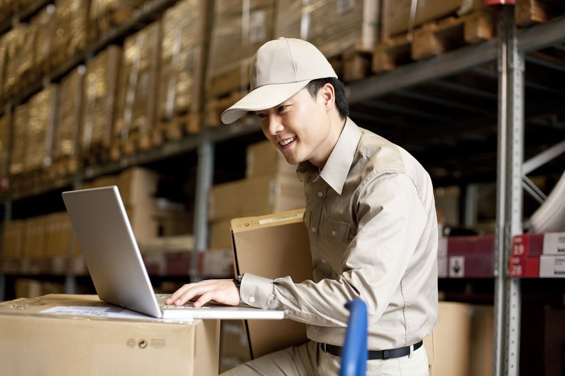 Male worker in a manufacturing facility working with his laptop