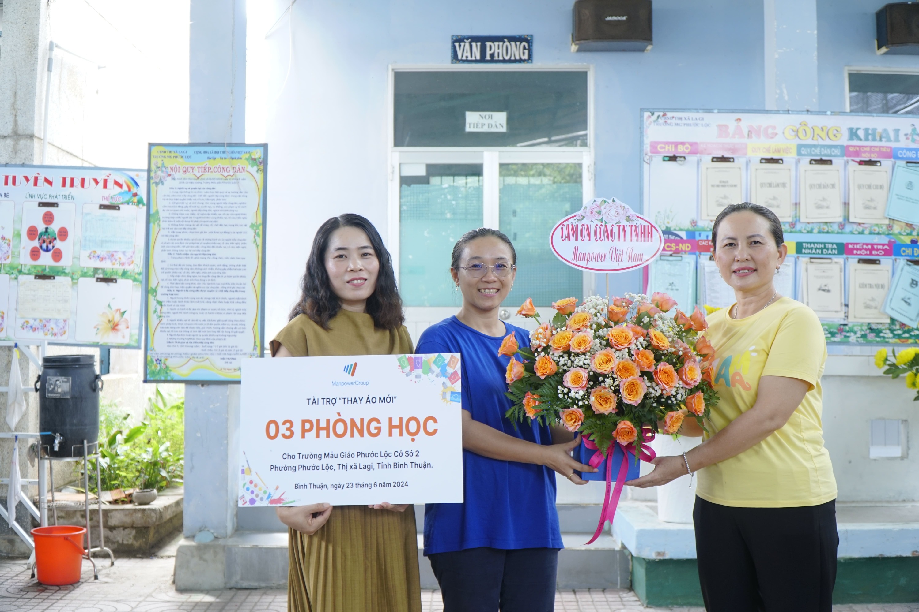 ManpowerGroup Vietnam’s employees take a photo with Phuoc Loc Kindergarten’s teachers in front of the newly refurbished, clean classrooms in a CSR program.