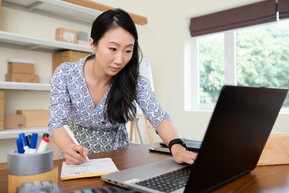 Female office worker checking and organizing files on computer 