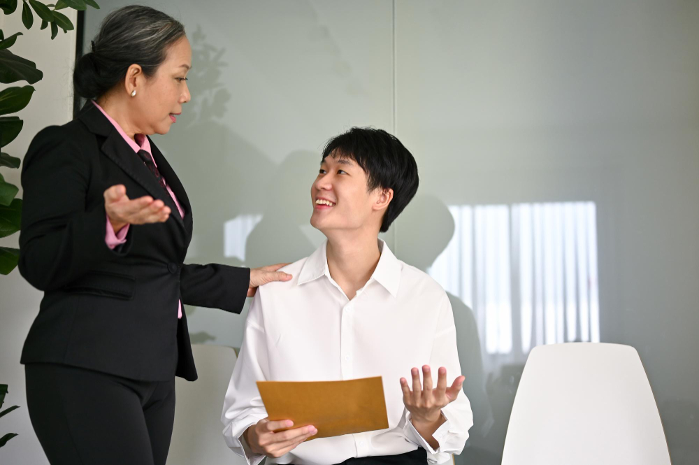 Employee and manager having friendly conversations each other 