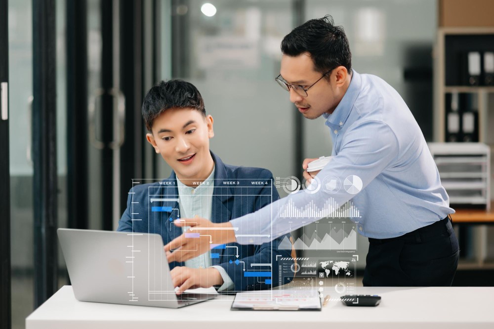 Co-workers in technology industry discussing about their work in the office