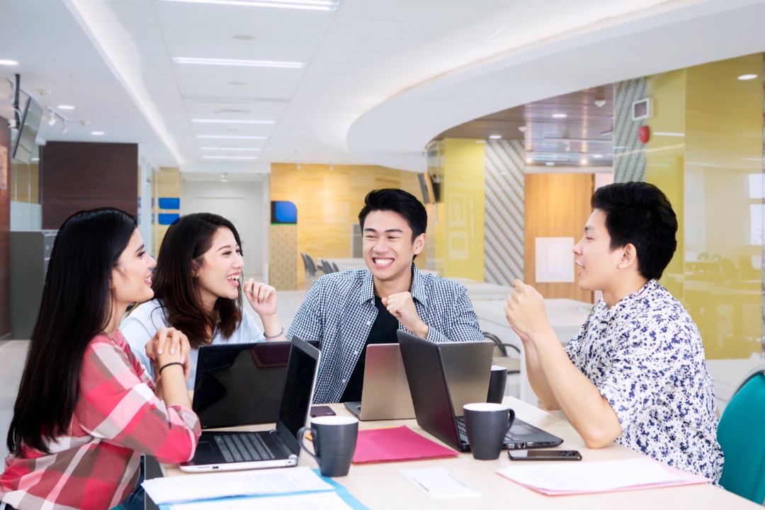 Group of employees discussing job hopping among young workers