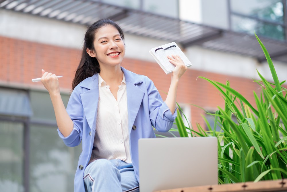 Female worker smiling after completing every task on her to-do list  