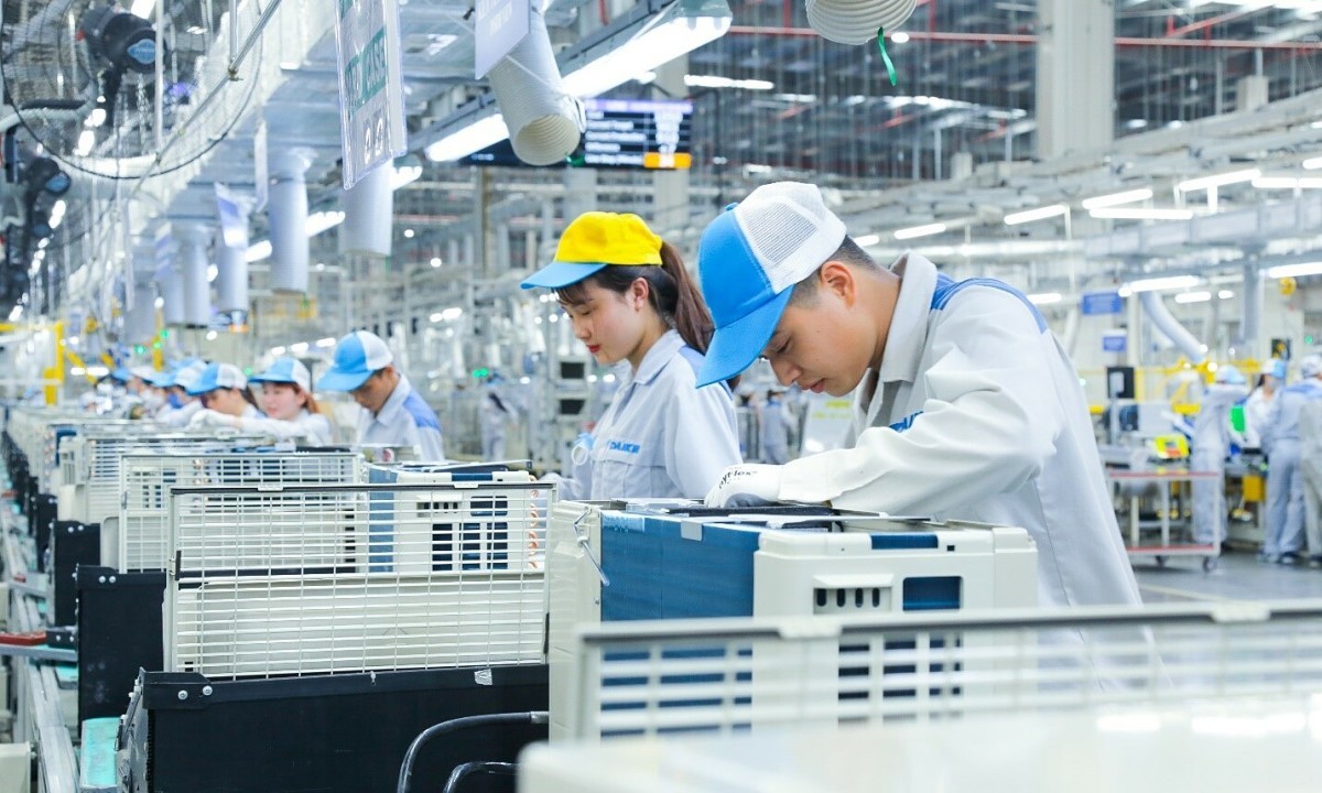Workers in uniforms working in a ready-built manufacturing factory
