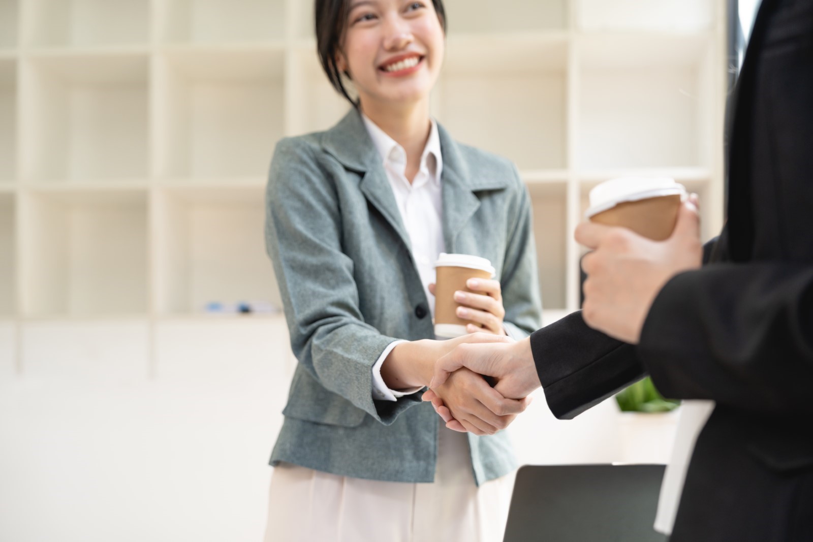 Female office worker shaking hands with a co-worker to strengthen their relationship