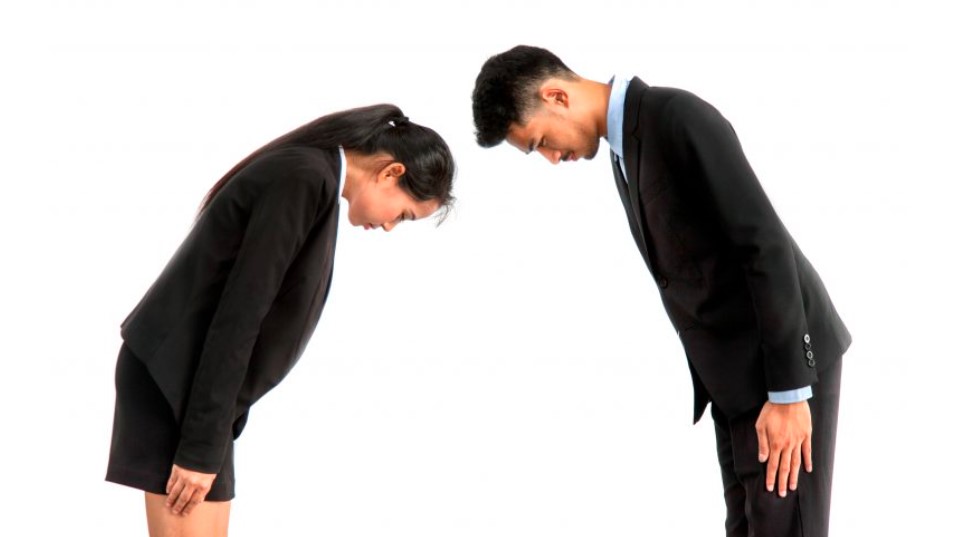 Candidates and employers bow to each other after the interview