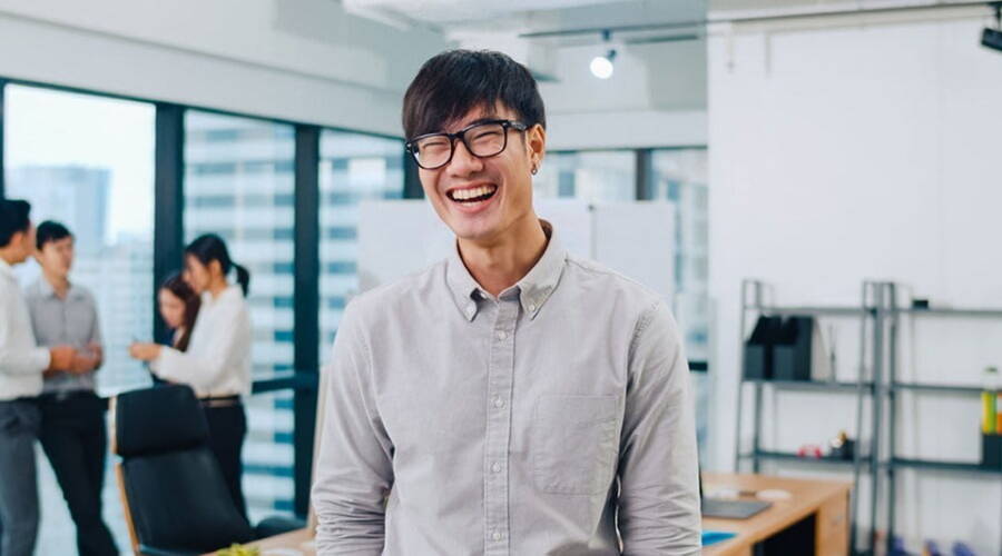 smiling male staff wearing glasses in the recruitment office